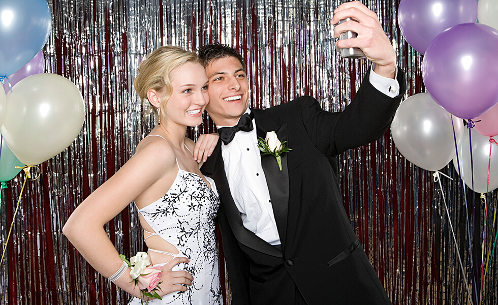 teenagers taking a selfie at prom